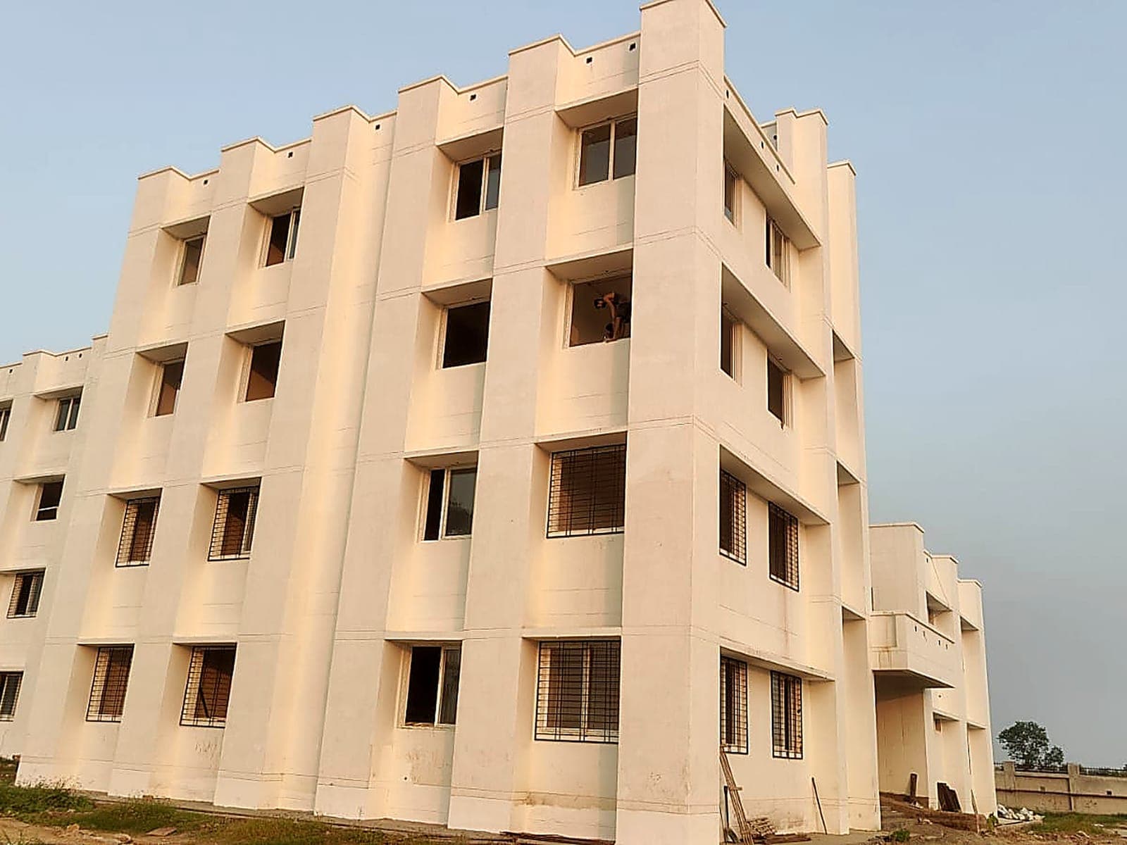 Four-storey white housing block with staggered facade